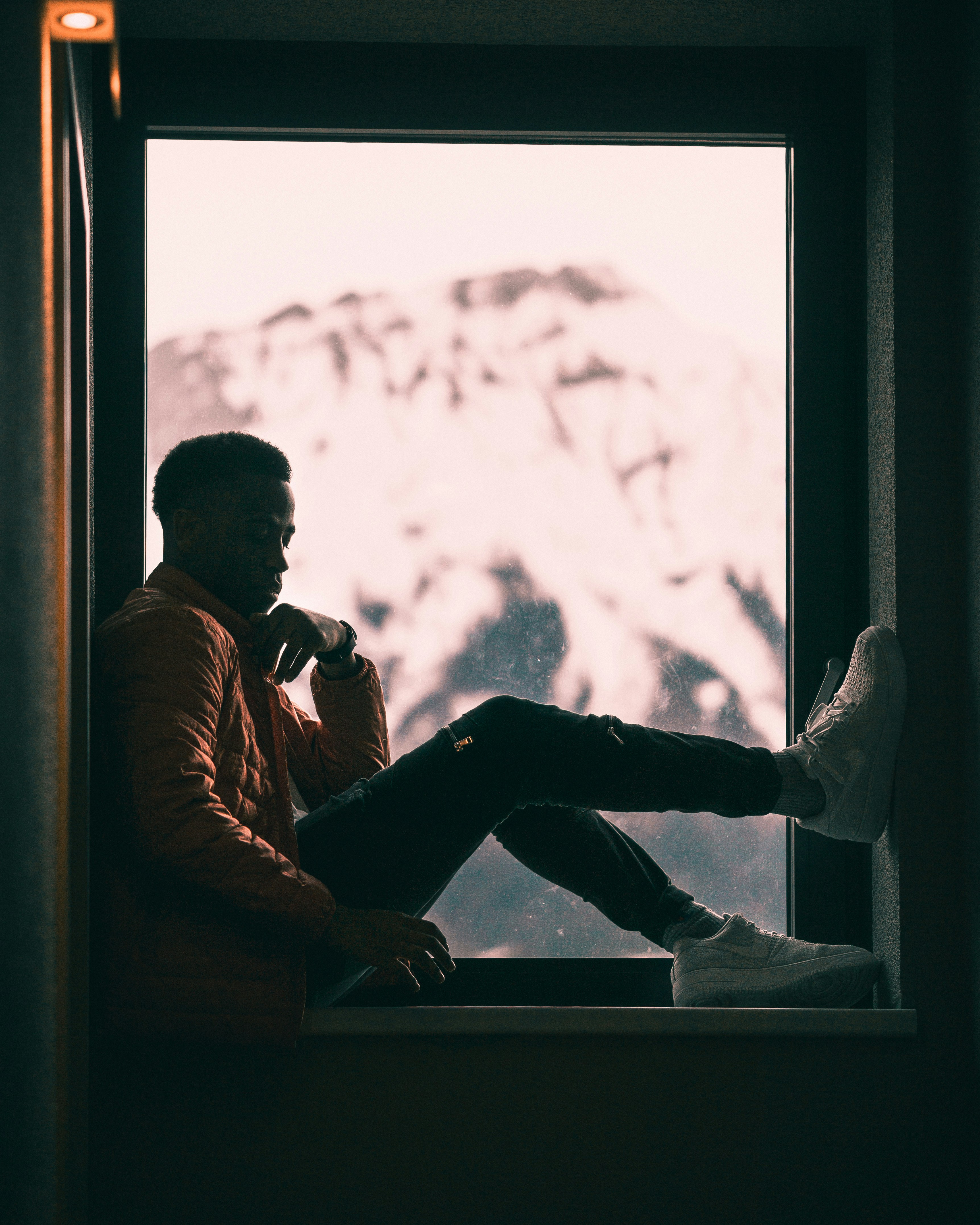 A learner seated in a quiet moment of reflection near a window